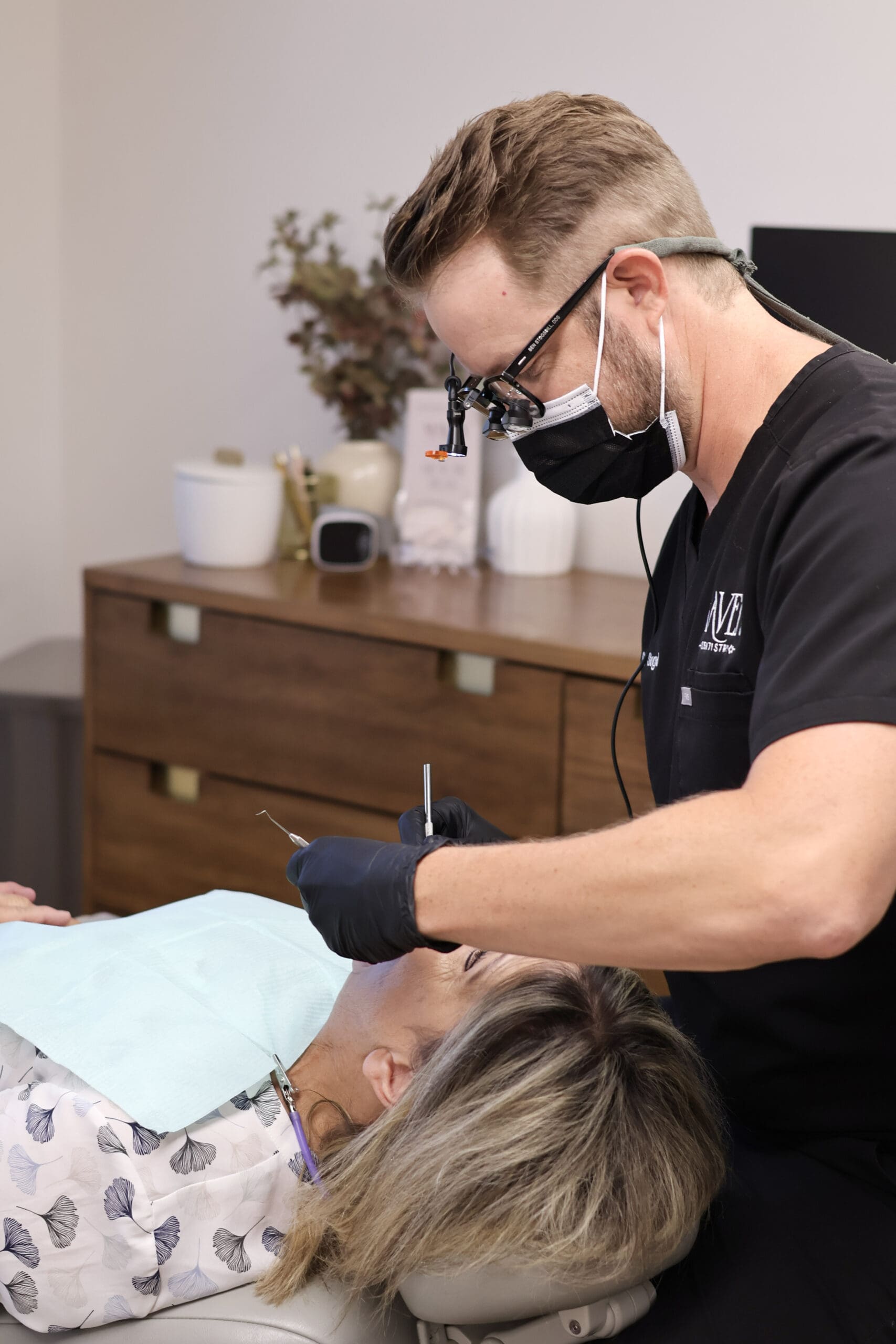 Dr. Stogsdill treating a patient as a family dentist in Albuquerque.